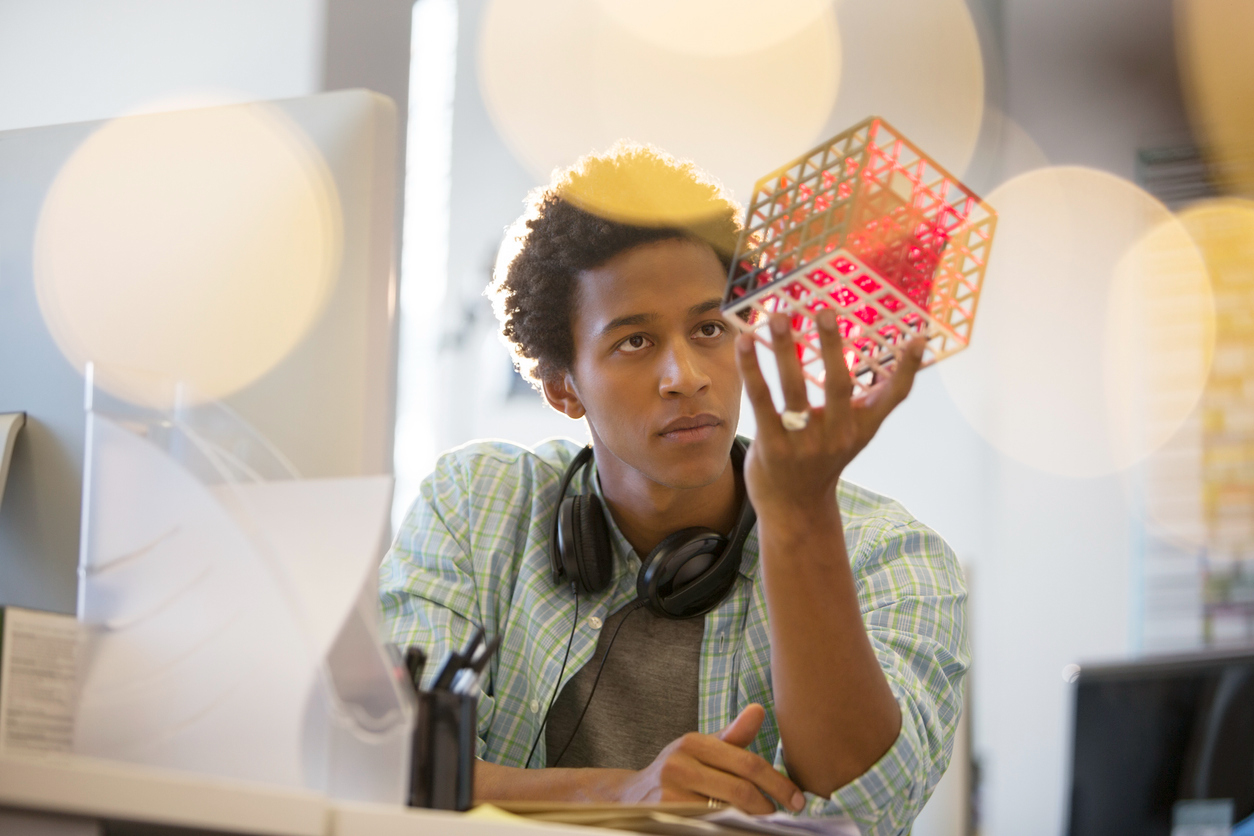 young man looking at a cube